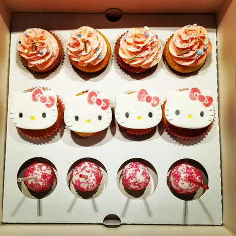 Boîte de cupcakes décorés d'une tête de Hello Kitty, et de cake pops